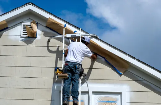 Masking windows on a Torrance home before painting