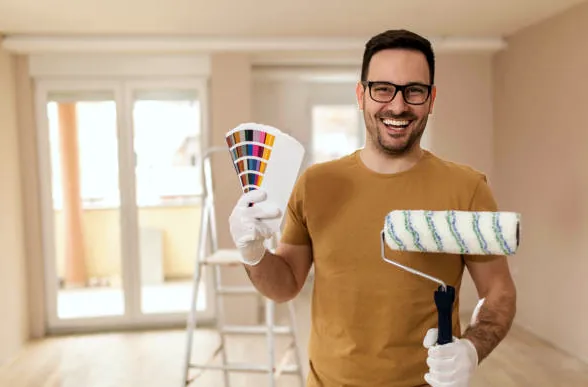 Torrance painter holding a roller and color fan deck